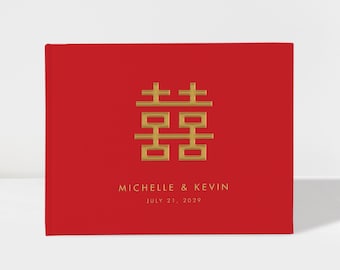 May include: Red guest book with gold foil text. The book features a traditional Chinese double happiness symbol and the names "Michelle & Kevin" with the date "July 21, 2029".