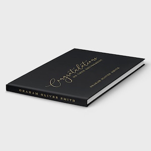 May include: Black hardcover book with gold lettering that reads "Congratulations on your retirement" and "Graham Oliver Smith".