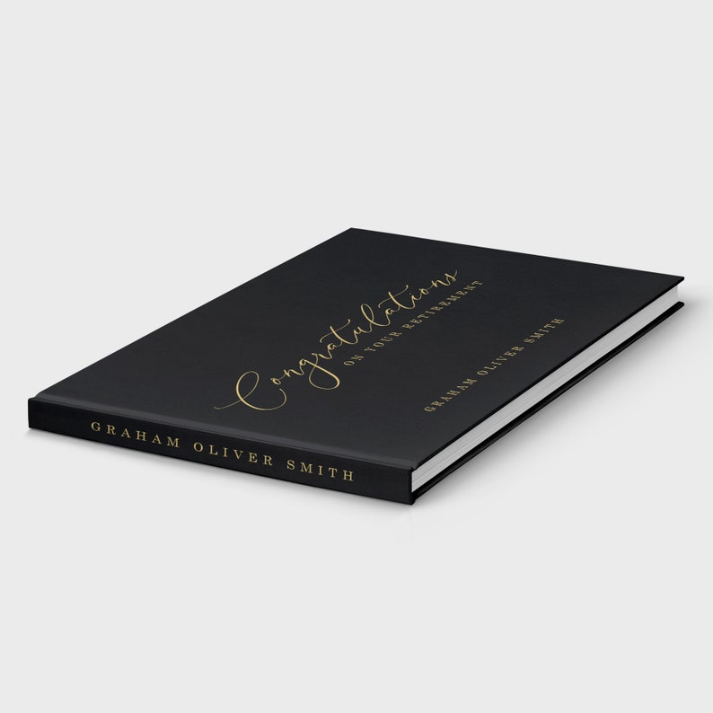 May include: Black hardcover book with gold lettering that reads "Congratulations on your retirement" and "Graham Oliver Smith".