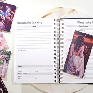 May include: A white spiral bound notebook with a blue cover and gold accents. The notebook has a section labeled "Photographer Summary" and another section labeled "Photography Shot List".