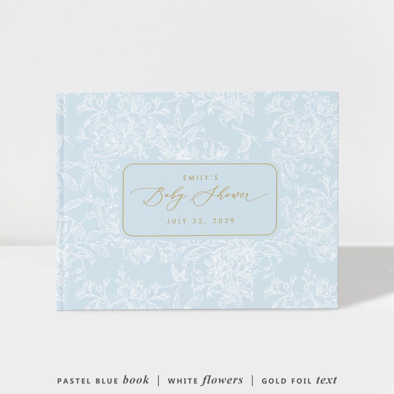 May include: A pastel blue baby shower book with white floral patterns. The book features gold foil text that reads "Emily's Baby Shower, July 22, 2029". The cover design includes a rectangular gold frame.