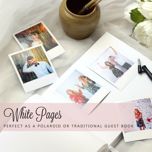 May include: A white guest book with the text "White Pages" and the phrase "Perfect as a Polaroid or Traditional Guest Book." Several Polaroid photos are scattered around the book, along with a pen and a small ceramic pot.