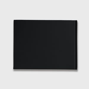 May include: A black hardcover book with a plain cover.
