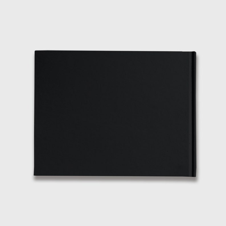 May include: A black hardcover book with a plain cover.