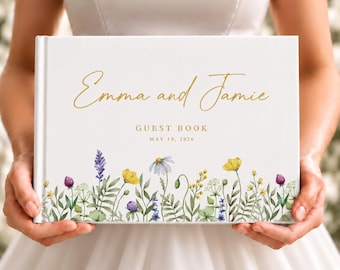 May include: A white guest book featuring the gold text Emma and Jamie, GUEST BOOK, and MAY 10, 2026. The bottom of the cover is decorated with a colorful watercolor illustration of various wildflowers, including yellow, purple, and blue blossoms.