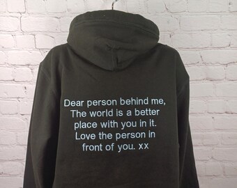 May include: Dark green hooded sweatshirt with the text "Dear person behind me, The world is a better place with you in it. Love the person in front of you. XX" printed on the back.
