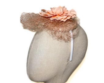 Peach colored fascinator with peach colored flower and veil, headband hat, hat with veil, cocktail hat