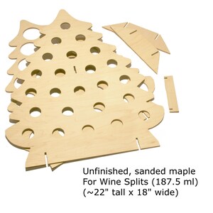 May include: Unfinished, sanded maple wine bottle holder shaped like a Christmas tree. It is designed to hold 187.5 ml wine splits and measures approximately 56 cm tall by 46 cm wide.