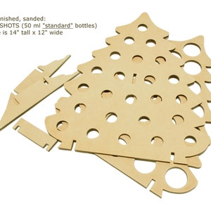 May include: Unfinished, sanded wooden Christmas tree shot glass holder. The tree is made of multiple pieces and is 14 inches tall by 12 inches wide. It is designed to hold 50 ml "standard" bottles.