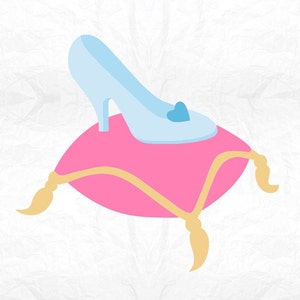 May include: A glass slipper with a blue heart detail sits on a pink pillow with gold trim.