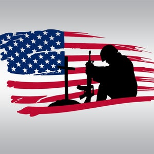 May include: Silhouette of a soldier kneeling in prayer in front of a cross, with a rifle resting on the ground. The soldier is positioned in front of a distressed American flag.