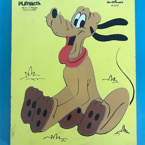May include: A yellow wooden puzzle featuring Pluto, a cartoon dog from Disney. The puzzle has 19 pieces and is recommended for ages 3 to 6 years. The puzzle is made by Playskool.
