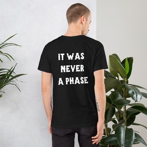 May include: Black t-shirt with white text that reads "It was never a phase."