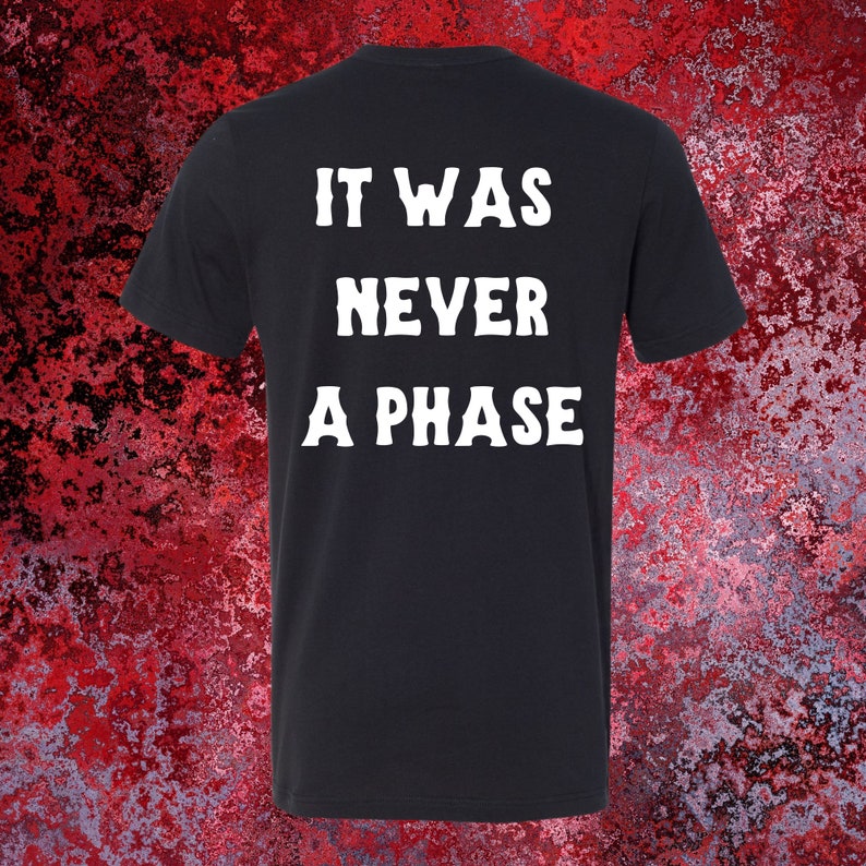 May include: Black t-shirt with white text that reads "It was never a phase."