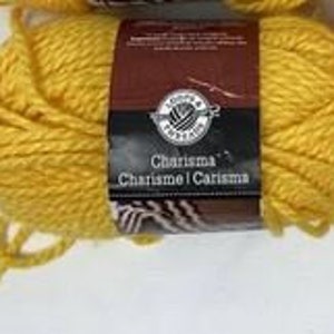 May include: A skein of yellow yarn labeled "Charisma" by Coats & Clark.
