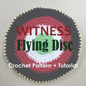 May include: A crocheted flying disc with a black, red, white, and green circular design. The text "WITNESS Flying Disc" is displayed in red and green. The words "Crochet Pattern + Tutorial" are also visible.