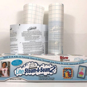 May include: A box of Lite Steam-A-Seam2 fusible web, a lighter alternative to traditional fusible web. The box is blue and white with a picture of a child wearing a shirt with a design made with the product. The box also features a grid pattern, which aids in tracing designs. The text on the box reads "NEW Grid Aids in Tracing! Easy to See Through and Trace On with Improved Stick!" and "Lite Steam-A-Seam2 The Lighter Alternative!"