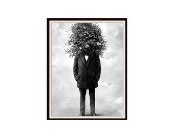 May include: Black and white framed art print featuring a person with a head of foliage. The person is wearing a dark coat, black pants, and dress shoes. The background is a cloudy, textured design.