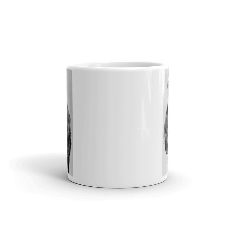 May include: White ceramic coffee mug with a black and white photo of a dog's face on one side.
