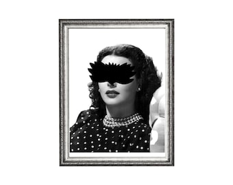May include: Black and white framed portrait of a woman with a black mask over her eyes. The woman is wearing a polka dot dress and a pearl necklace. The frame is silver with ornate detailing.
