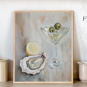 May include: A framed painting depicting a martini glass with olives, a lemon slice, and an oyster. The painting is on a kitchen counter with a pink toaster, mugs, and wooden chopping boards. The Fairfield Fine Art logo is visible.