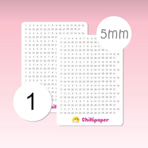 May include: A white circle with the number "1" printed in black. The circle is surrounded by a grid of numbers from 1 to 31, with the text "5mm" printed in gray at the top right corner. The grid is on a pink background.