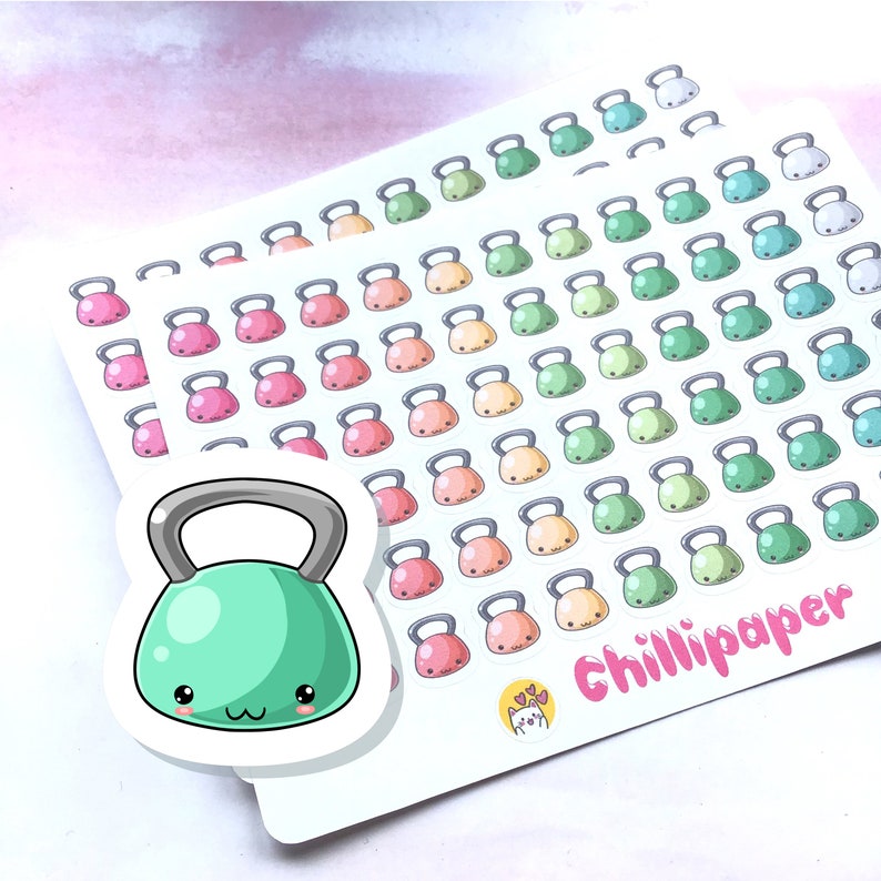 May include: A sheet of stickers featuring a variety of colorful cartoon kettlebells. The stickers are arranged in rows and columns, with each kettlebell having a different color and expression. The sheet also includes a larger sticker of a green kettlebell with a cute face.
