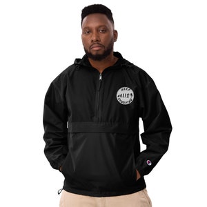May include: Black windbreaker jacket with a zipper closure and a white circle logo on the front that says "Keep Evolving" with a silhouette of a human evolution chain.