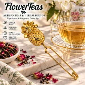 May include: A gold-toned metal tea infuser shaped like a pineapple with a long handle and a spring-loaded mechanism. The infuser features a perforated body for steeping loose leaf tea. The text FlowerTeas Artisan Teas & Herbal Blends is visible.