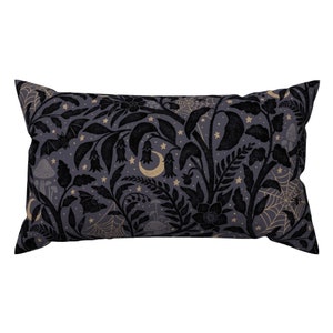 May include: A black and gold throw pillow with a spooky forest pattern. The pattern features bats, mushrooms, stars, and a crescent moon.