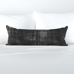 May include: A black and gray patterned lumbar pillow with a soft, textured fabric.