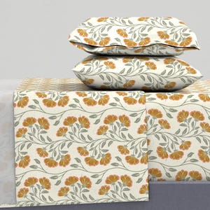 May include: A white bedding set with a floral pattern featuring orange flowers and green leaves. The set includes a flat sheet, fitted sheet, and two pillowcases.