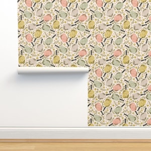 May include: A seamless pattern wallpaper featuring a repeating design of pastel-colored paddleball rackets with green leaves and small white flowers on a cream background.