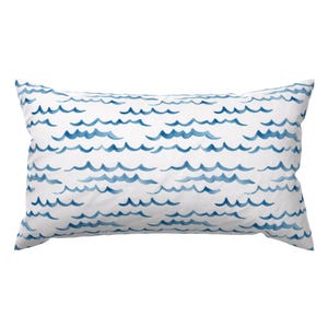 May include: A white pillow with a blue watercolor wave pattern.