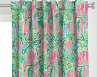 May include: A curtain panel featuring a repeating pattern of palm trees in shades of bright pink, teal, light blue, and lime green. The fabric is gathered at the top and hangs from a silver metal curtain rod with a smooth, cylindrical finish.