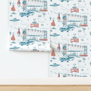 May include: Wallpaper roll featuring a retro mid-century modern design. The pattern includes illustrations of motels, classic cars, rockets, UFOs, and women in dresses, all in shades of blue, red, and white against a light background.