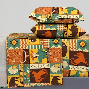 May include: A patchwork quilt set with a southwestern theme. The quilt features a variety of patterns, including paisley, stars, and geometric designs. The colors are a mix of orange, yellow, green, and brown. The quilt set includes a duvet cover, two pillowcases, and a decorative throw pillow.