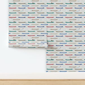 May include: A seamless pattern featuring a repeating design of colorful canoes on a light beige background. The canoes are in various colors, including red, blue, green, and white.