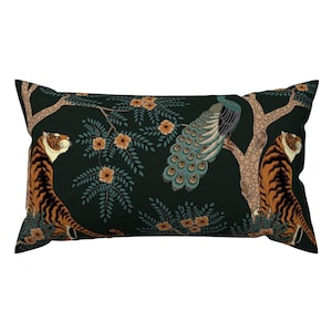May include: Rectangular decorative pillow with a dark green background featuring a tiger and a peacock. The tiger has orange and black stripes, and the peacock has blue and green feathers. The pillow has a floral and tree branch design.