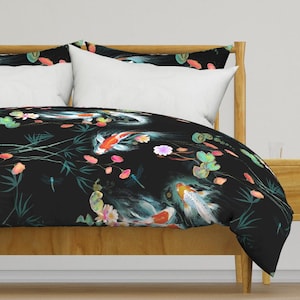 May include: Black duvet cover featuring a repeating pattern of colourful koi fish, water lilies and dragonflies. The pattern is set against a dark background.