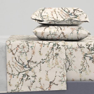 May include: A white bedding set with a floral pattern of blooming branches. The set includes a fitted sheet, flat sheet, and two pillowcases.