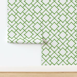 May include: A roll of wallpaper featuring a repeating geometric lattice pattern composed of green bamboo-style stalks on a solid white background. The design creates a series of interconnected diamond shapes across the surface of the paper.
