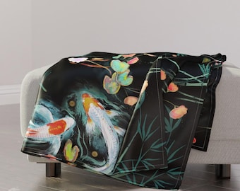 May include: A black throw blanket with a colorful koi fish and water lily design. The blanket features a dark background with green bamboo stalks and pink and yellow water lilies.