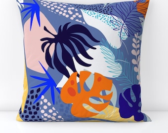 May include: A blue, white, orange, and yellow throw pillow with a tropical leaf pattern.