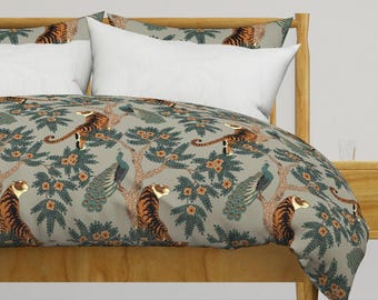 May include: A gray duvet cover with a repeating pattern of tigers, peacocks, and floral designs. The duvet cover is on a wooden bed frame.