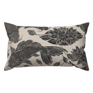 May include: A rectangular throw cushion featuring a cream-coloured background with a black ink-style illustration pattern. The design depicts koi fish swimming among detailed lotus flowers, buds, and a small dragonfly, creating a repeating motif.