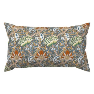 May include: A rectangular pillow with a blue background and a repeating floral pattern in shades of green, orange, and yellow.