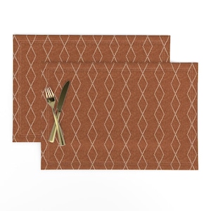 May include: Two brown placemats with a white diamond pattern. The placemats are made of a textured fabric and have a subtle sheen.
