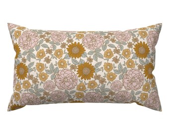 May include: A rectangular pillow with a floral pattern. The pillow features a cream background with pink and yellow flowers. The flowers are outlined in brown.