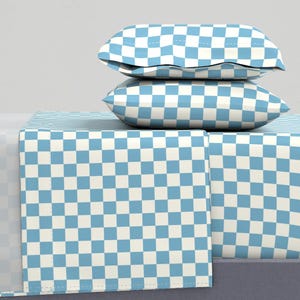 May include: A blue and white checkered bed sheet set with two matching pillowcases. The sheet set is made of soft, comfortable fabric and is perfect for adding a touch of style to any bedroom.